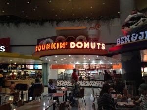 One of the many airport Dunkin Donuts I've seen on a layover, just ahead like a shining beacon of hope.
