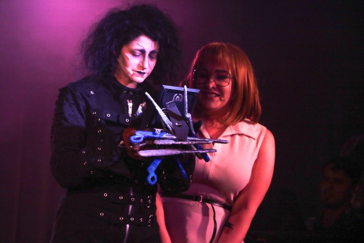 Jordan Kai Burnett as Scissorhands - Emma Hunton as Peg - smirking